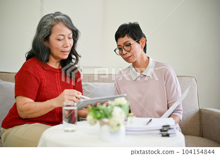 A beautiful mature middle-aged Asian female health insurance agent visited a retired woman A beautiful mature middle-aged Asian female health insurance agent visited a retired woman 104154844