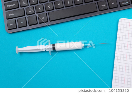 Vaccination or Revaccination Concept - A Medical Syringe on Blue Table Vaccination or Revaccination Concept - A Medical Syringe on Blue Table 104155230
