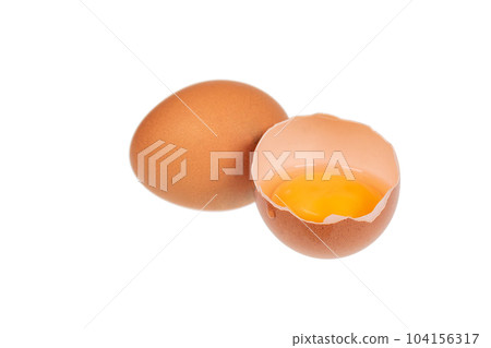 Yolk in an eggshell on a white background. Yolk in an eggshell on a white background. 104156317