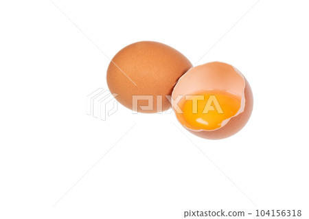 Yolk in an eggshell on a white background. 104156318