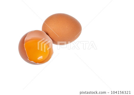 Yolk in an eggshell on a white background. 104156321