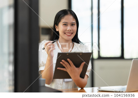 Financier a asian woman works, uses a laptop, makes a report to a finance company. Accounting and financial concept 104156936
