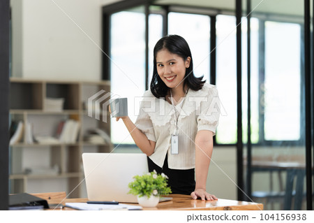 Financier a asian woman works, uses a laptop, makes a report to a finance company. Accounting and financial concept Financier a asian woman works, uses a laptop, makes a report to a finance company. Accounting and financial concept 104156938