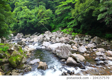 Beautiful touristic scenery of Cheonjeyeon Waterfall, a famous tourist attraction in Jeju Island. 104157570