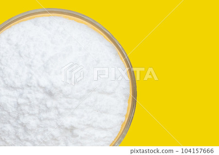 Baking soda on yellow background. Baking soda on yellow background. 104157666