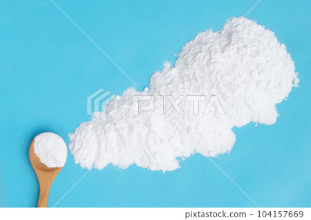 Baking soda on blue background. 104157669