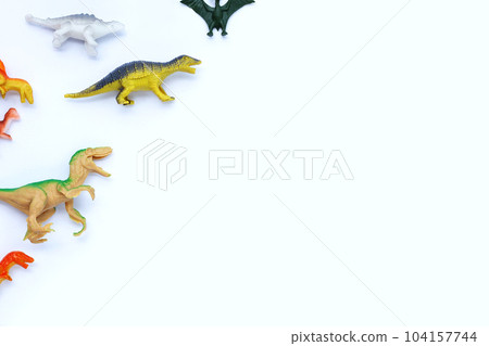 Plastic dinosaur toys on white background. Top view Plastic dinosaur toys on white background. Top view 104157744
