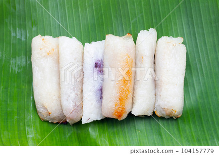 Grilled sticky rice in banana leaves with banana filling 104157779