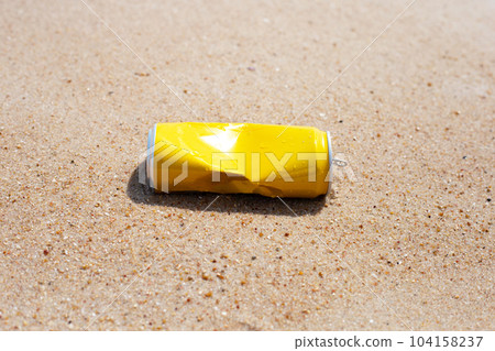Yellow can waste on the beach 104158237