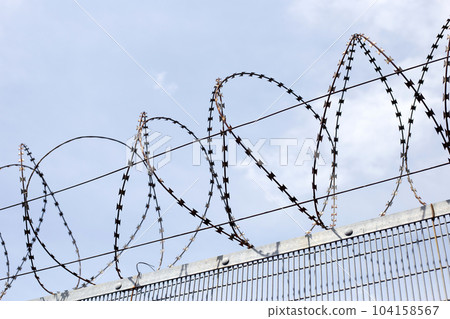 Barbed wires against sky. Wired fence Barbed wires against sky. Wired fence 104158567