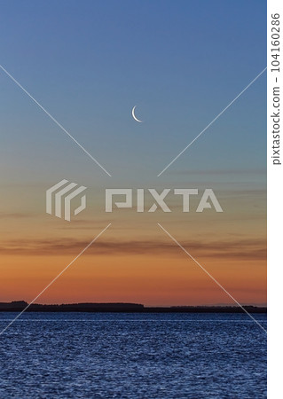 Seaside landscape with crescent Moon 104160286