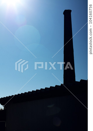 Brick chimneys in the city stand against the blue sky Brick chimneys in the city stand against the blue sky 104160756
