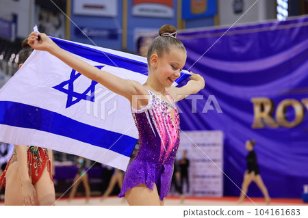 Portrait of patriotic young gymnast holding national flag of Israel 104161683