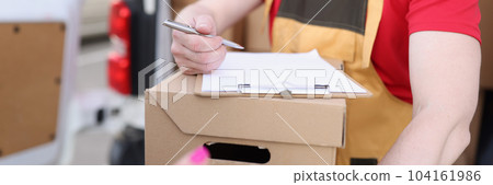 Courier gives pen to the client to sign on delivery receipt Courier gives pen to the client to sign on delivery receipt 104161986