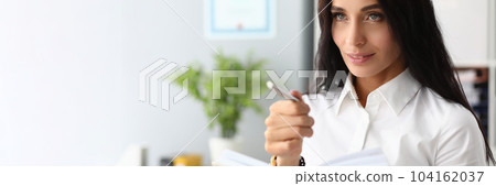 Portrait of a pensive beautiful businesswoman with pen and diary Portrait of a pensive beautiful businesswoman with pen and diary 104162037