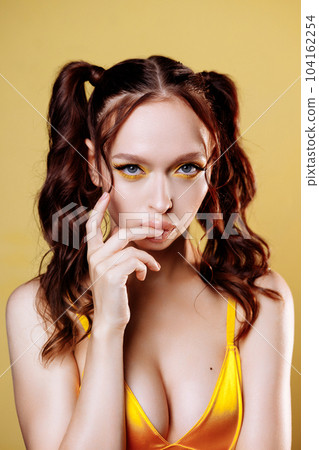 Young Adult Woman with Long Red Hair and Confident Look in Studio Portrait Young Adult Woman with Long Red Hair and Confident Look in Studio Portrait 104162254