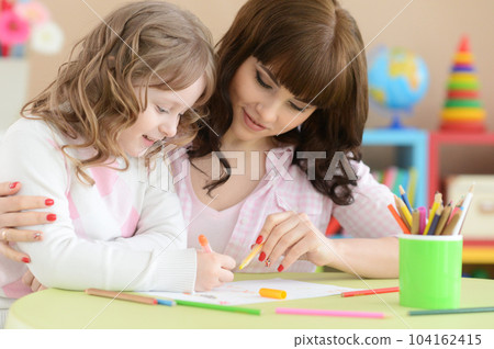 little girl and mother drawing with pencils 104162415
