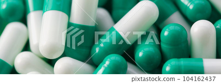 Lots of medical white green pills and vitamins closeup Lots of medical white green pills and vitamins closeup 104162437
