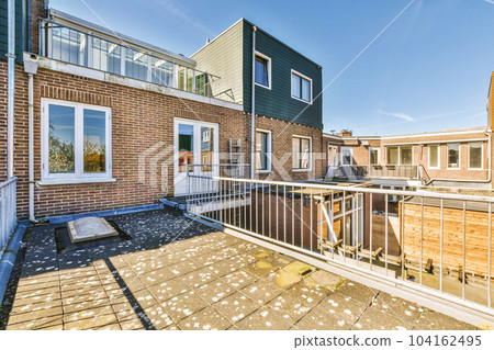 the outside of a house with brick walls and white trim around the balcony railings, windows, and doors the outside of a house with brick walls and white trim around the balcony railings, windows, and doors 104162495