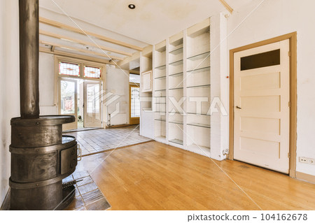 the inside of a house with wood floors and an open fire place in the middle of the room to the right 104162678
