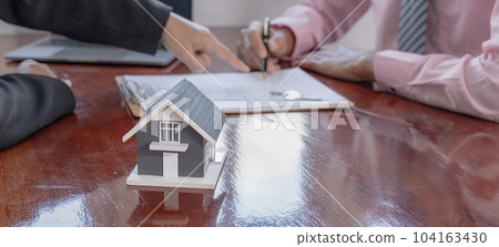 home model. The real estate agent explains the business contract home model. The real estate agent explains the business contract 104163430