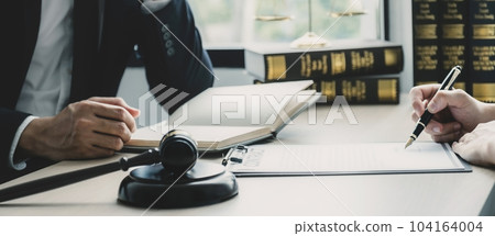 Businessman hand sign after Lawyer providing legal consult dispute service at the office with justice scale and gavel hammer 104164004