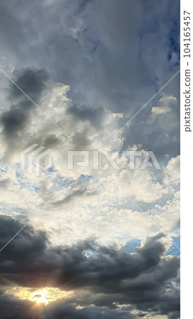 Blue sky with clouds, flying birds and a rainbow. Summer nature. Clouds at sunset. 104165457