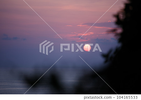 Purple sunset with clouds on the ocean Purple sunset with clouds on the ocean 104165533