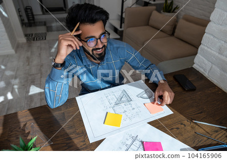 Man working on papers of the construction project 104165906