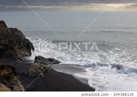 Rocky coast and Atlantic ocean, Dyrholaey, south Iceland 104166126
