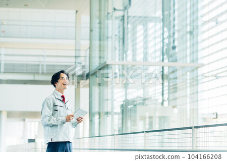 A worker carrying out an inspection with a tablet in an office building 104166208