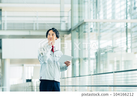 A worker carrying out an inspection with a tablet in an office building A worker carrying out an inspection with a tablet in an office building 104166212