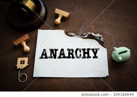 Anarchy. A burning white sheet of paper on a rusting metal background 104166649