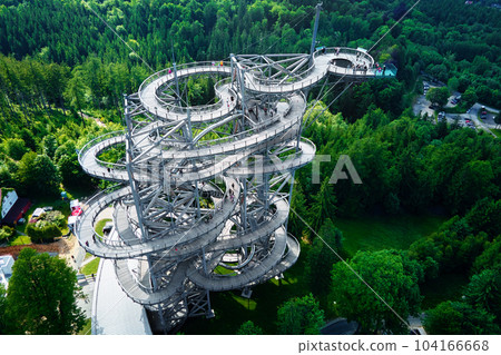Sky Walk observation tower in Sweradow Zdroj, Poland. Tourist attraction in montains, aerial view. Panoramic view of nature landscape with green forest 104166668
