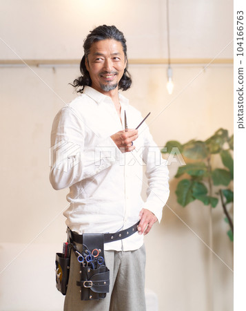Experienced hairdresser posing with scissors Experienced hairdresser posing with scissors 104166763
