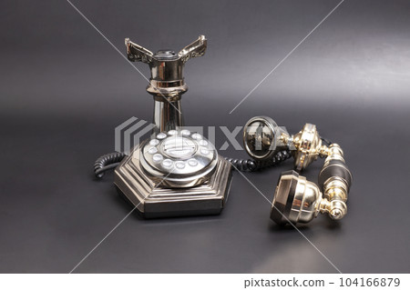 Vintage telephone on black background. Vintage telephone on black background. 104166879