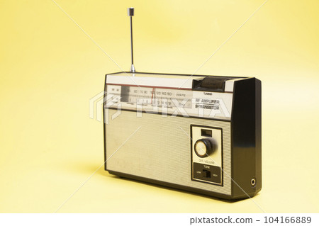 Vintage transistor radio on a yellow background 104166889