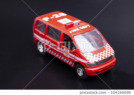 fire dept car toy on black background. fire dept car toy on black background. 104166896