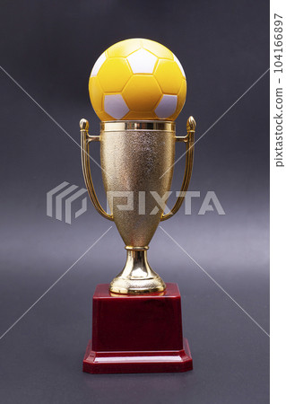 Gold cup with soccer ball on a black background 104166897