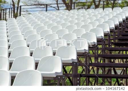 Seats of tribune on sport stadium. Concept of fans, chairs for audience, cultural environment concept. mpty seats, modern stadium. Seats of tribune on sport stadium. Concept of fans, chairs for audience, cultural environment concept. mpty seats, modern stadium. 104167142