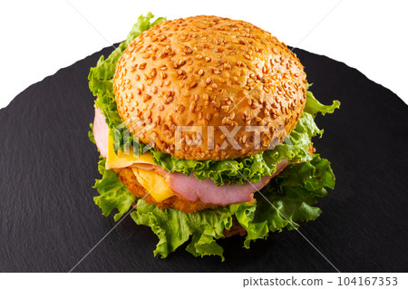 Burger with sesame bun, cutlet, yellow sauce, salad, fresh cucumbers and cheese. Burger with sesame bun, cutlet, yellow sauce, salad, fresh cucumbers and cheese. 104167353
