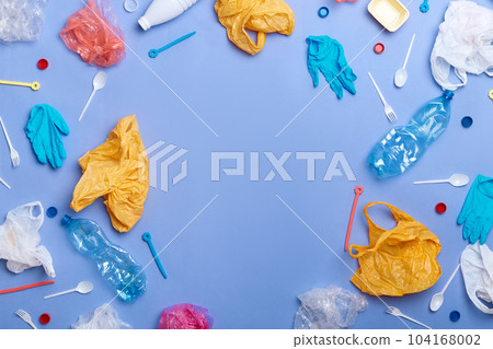 Living on clean Earth, picked plastic litter isolated on blue wall. Save environment. Nobody. Being ecologically friendly, saves planet from contamination, stop destroying our planet. Copy space. 104168002