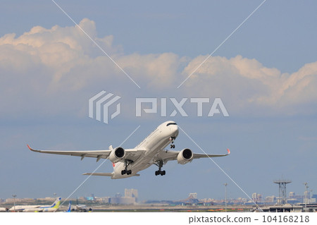 Passenger plane taking off and rising in the summer sky Passenger plane taking off and rising in the summer sky 104168218