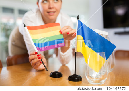 Flag of Ukraine and rainbow flag of LGBT on negotiating table 104168272