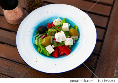 Salad with olives, tomatoes, cucumber and feta cheese - greek vegetable salad. Traditional mediterranean cuisine 104169063