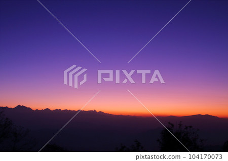 A view of the Himalayas in the sunrise sky from Nagarkot, a village on the outskirts of Kathmandu, Nepal in South Asia A view of the Himalayas in the sunrise sky from Nagarkot, a village on the outskirts of Kathmandu, Nepal in South Asia 104170073