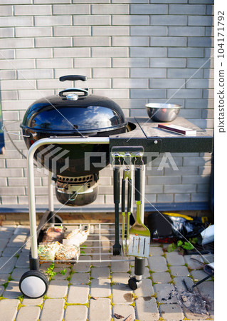 Barbecue by the brick wall. Installation for cooking on coals 104171792