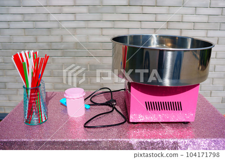Cotton candy machine on a table in the yard. Cotton candy machine on a table in the yard. 104171798