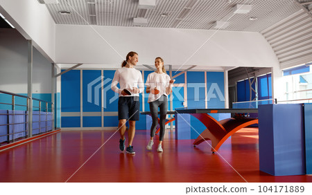 Two table tennis player walking and talking after training at sport club 104171889