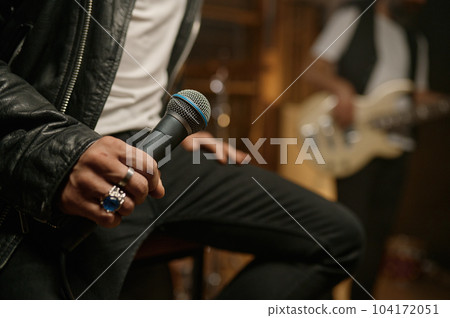 Closeup view of rock singer hand holding dynamic microphone Closeup view of rock singer hand holding dynamic microphone 104172051